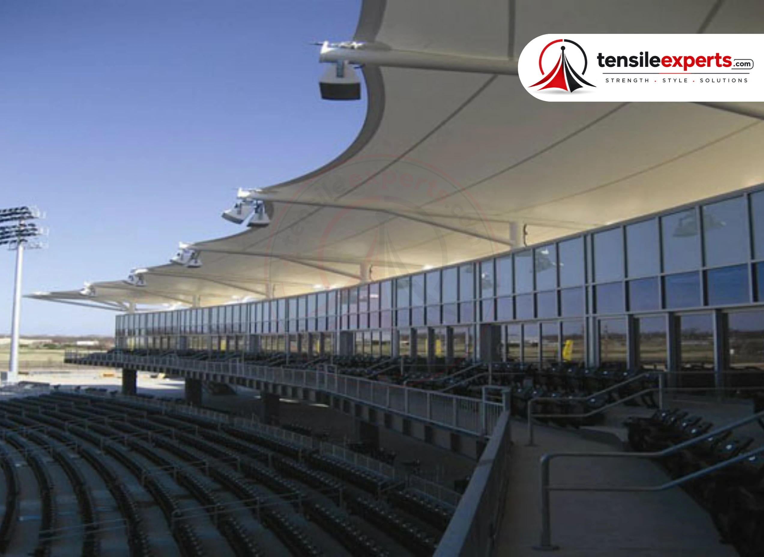 A large tensile canopy roof over tiered amphitheater-style assembly seating.