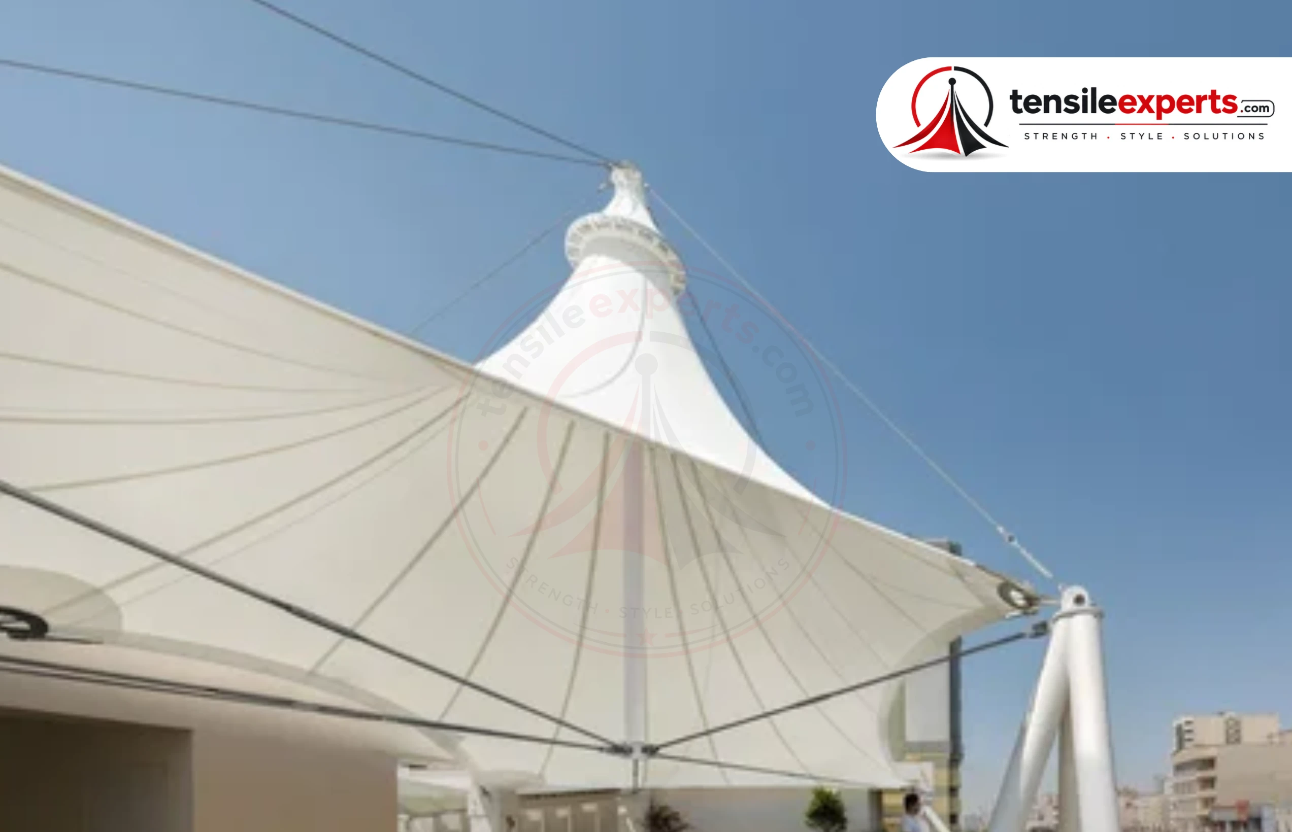 A tensile canopy structure covering a walkway — the standard choice for a fixed-path or entrance-approach shade need.