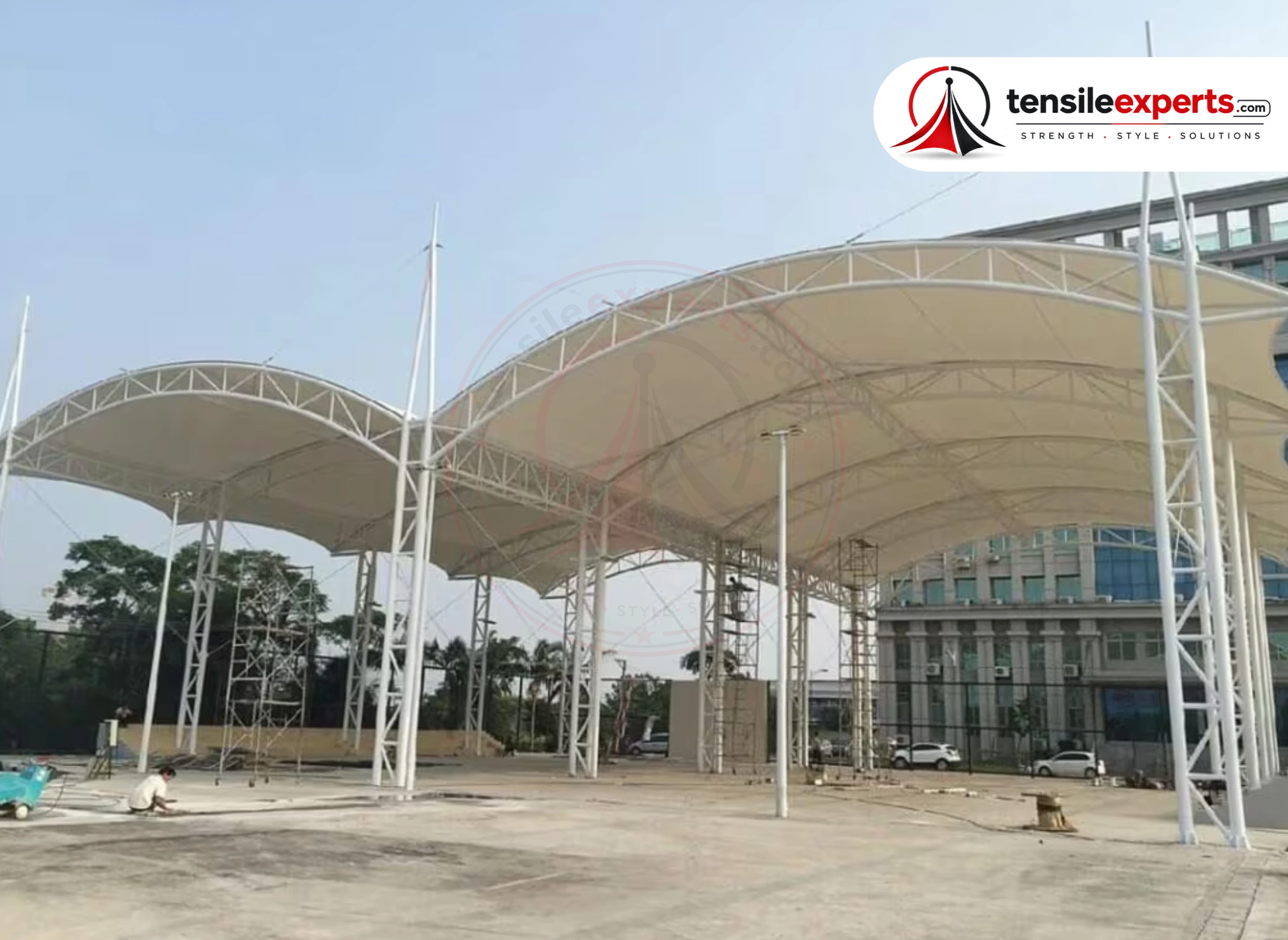 A large tensile entrance structure — a barrel-vault statement canopy at a commercial facade.