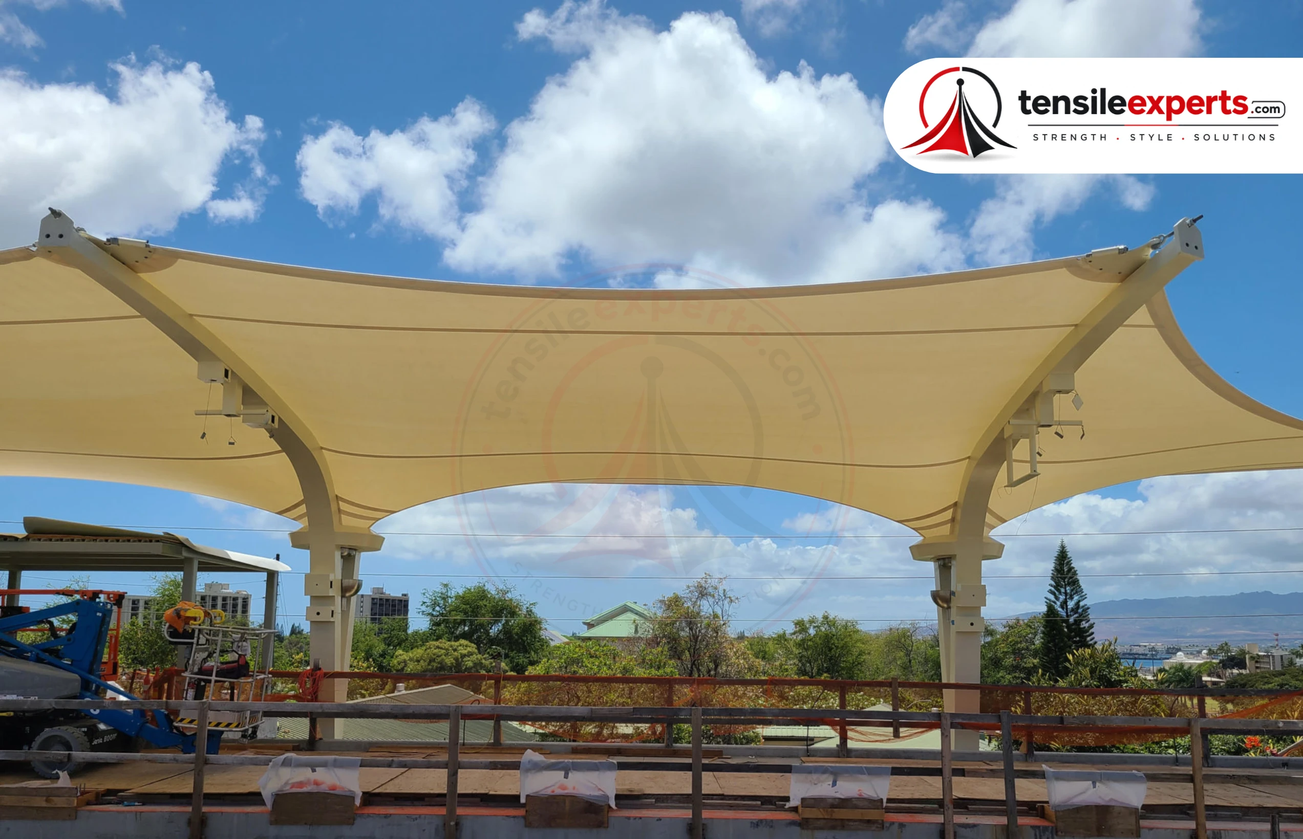 A tensile membrane roof — the double-curved geometry visible against the sky.