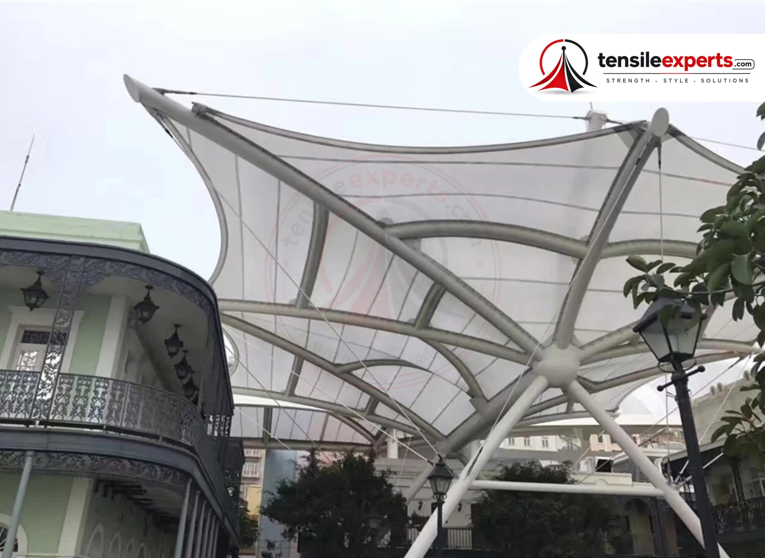 A translucent tensile canopy bringing daylight into a heritage-building courtyard.