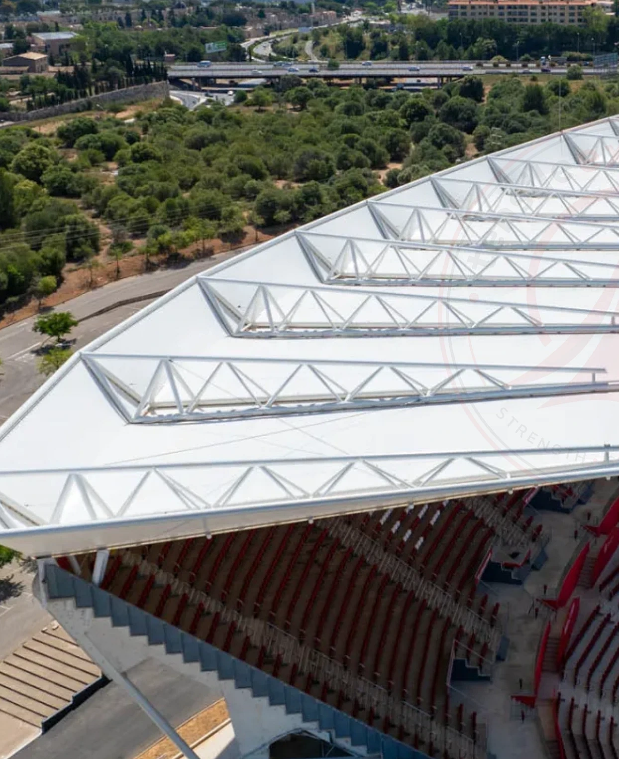 Aerial view of triangulated steel truss roof structure before fabric membrane installation